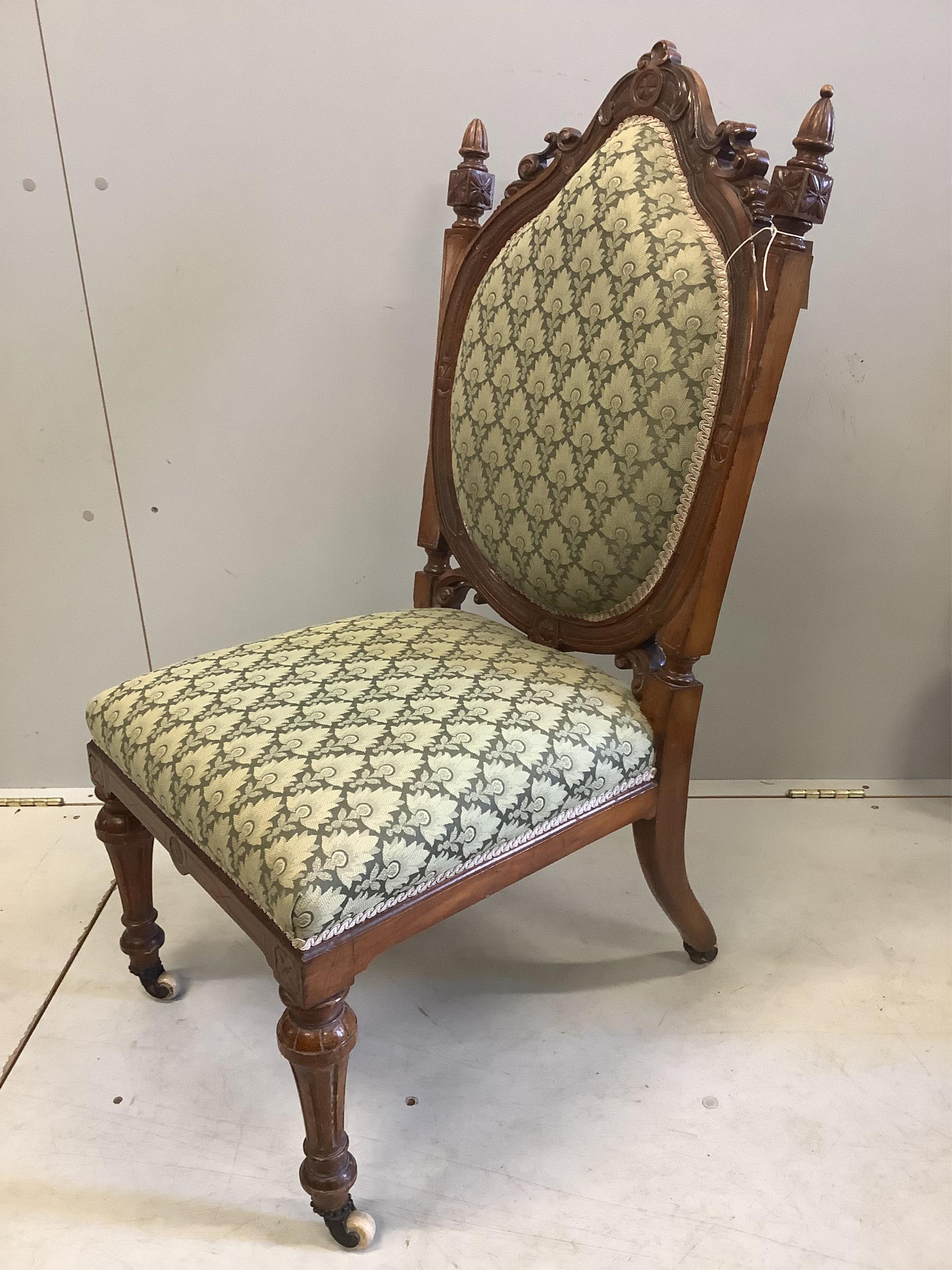 A Victorian walnut nursing chair, width 50cm, depth 58cm, height 101cm